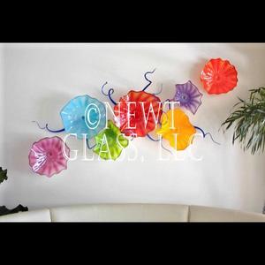 Opaque Spring
 
	Opaque blown glass wall flowers with squiggles
