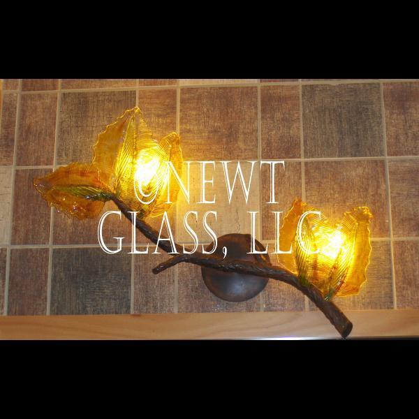 Forest Branch
 
	Metal and blown glass sconce made to look like a branch with leaves
